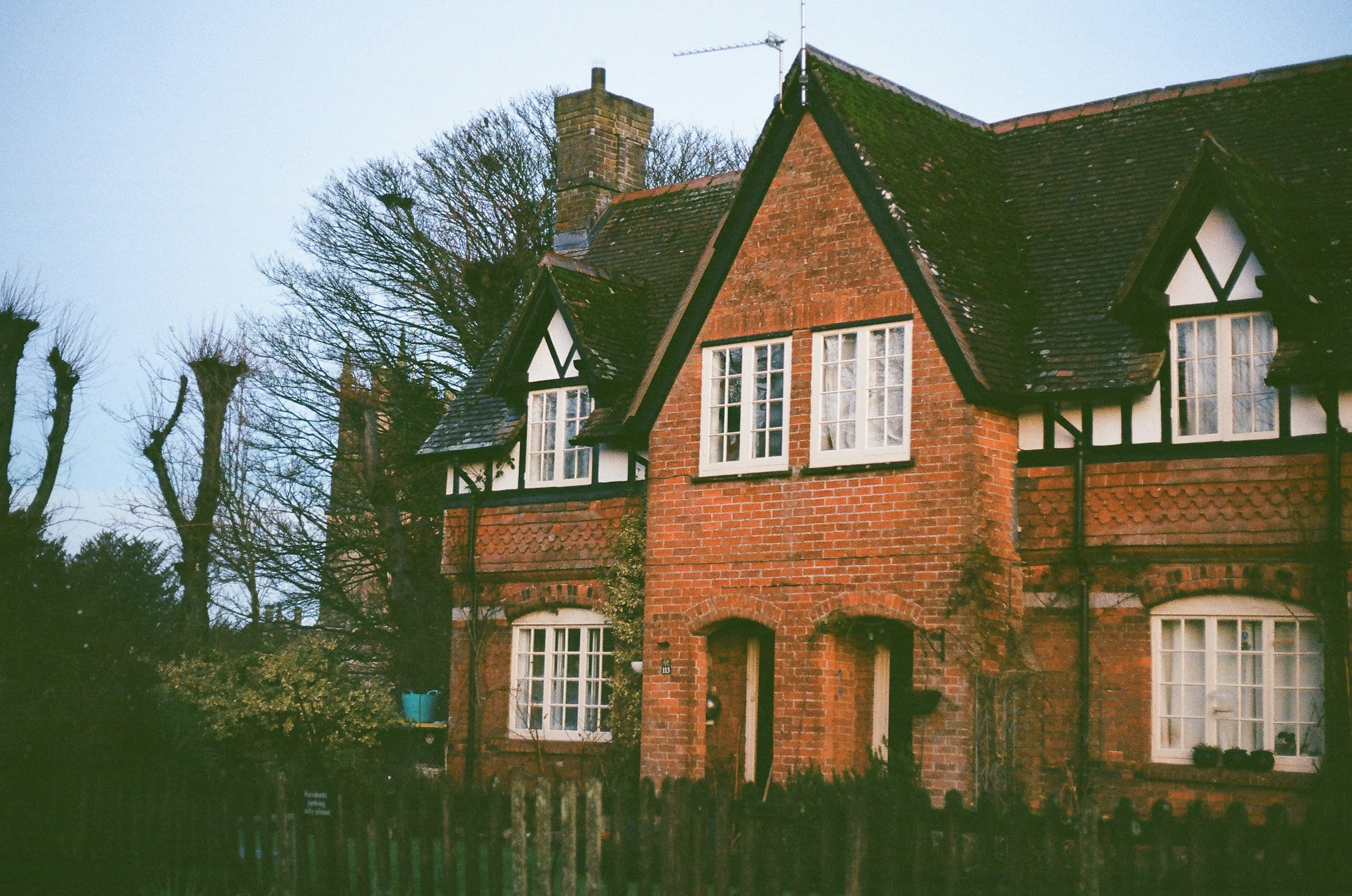 A brick house with white window frames